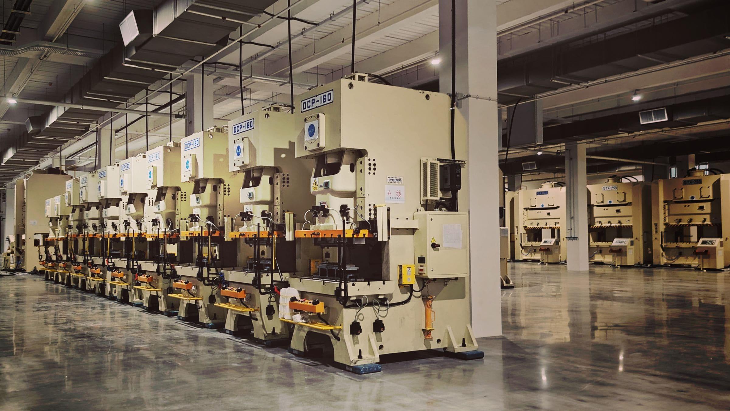 Row of mechanical presses on a metalworking shop floor
